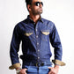 Man wearing a denim shirt and jeans on a white background
