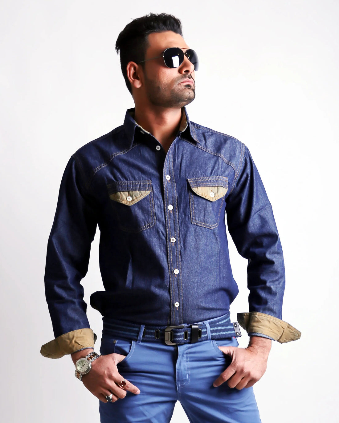 Man wearing a denim shirt and jeans on a white background