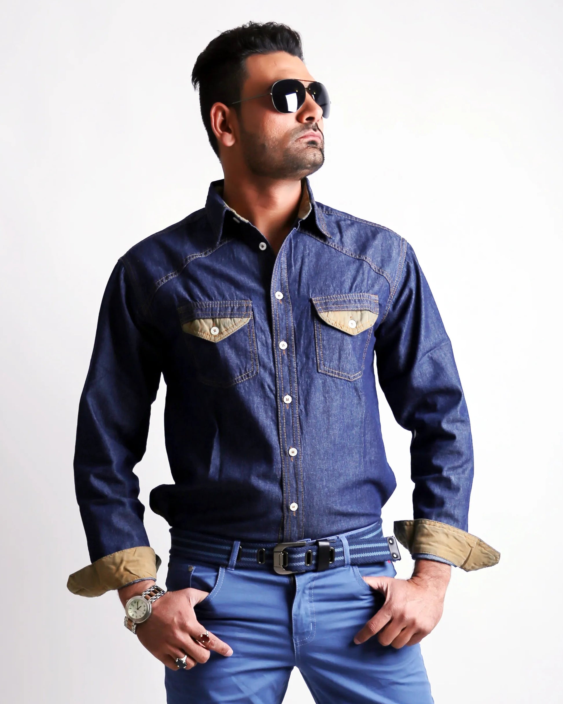 Man wearing a denim shirt and jeans on a white background