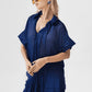 Loose fit short sleeve linen shirt with ruffle front.