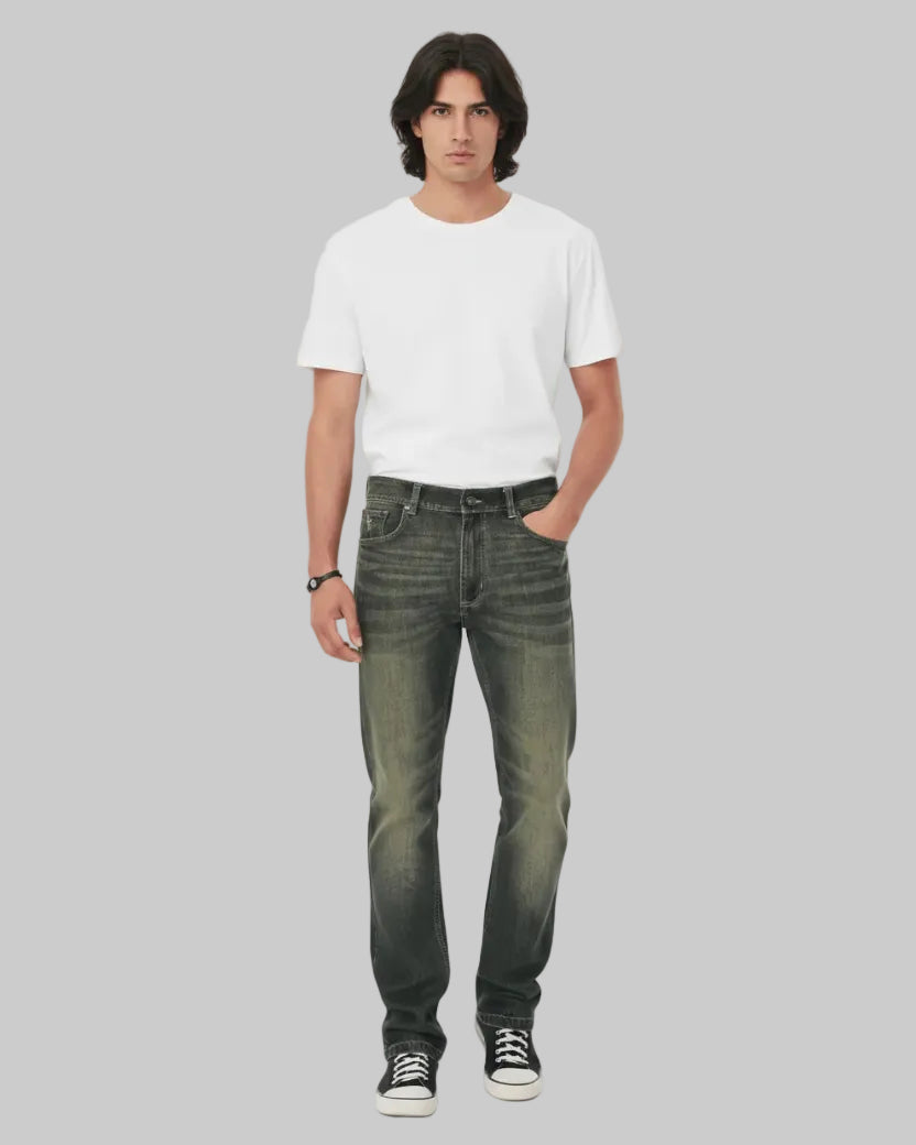 Person wearing dark jeans and black sneakers on a white background