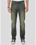 Person wearing dark jeans and black sneakers on a white background