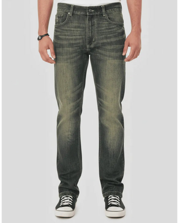Person wearing dark jeans and black sneakers on a white background