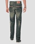 Person wearing dark green distressed jeans on a white background