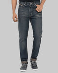 Person wearing blue jeans on a gray background