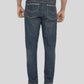 Person wearing blue jeans on a plain background