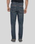 Person wearing blue jeans on a plain background