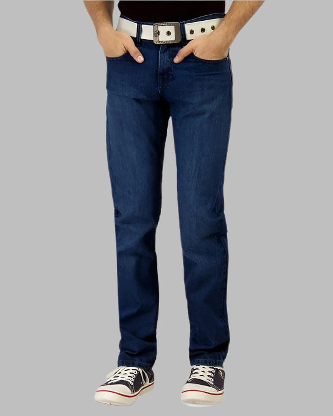 Person wearing blue jeans with a belt on a gray background