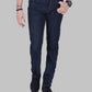 Person wearing dark blue jeans on a gray background
