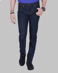Person wearing dark blue jeans on a gray background