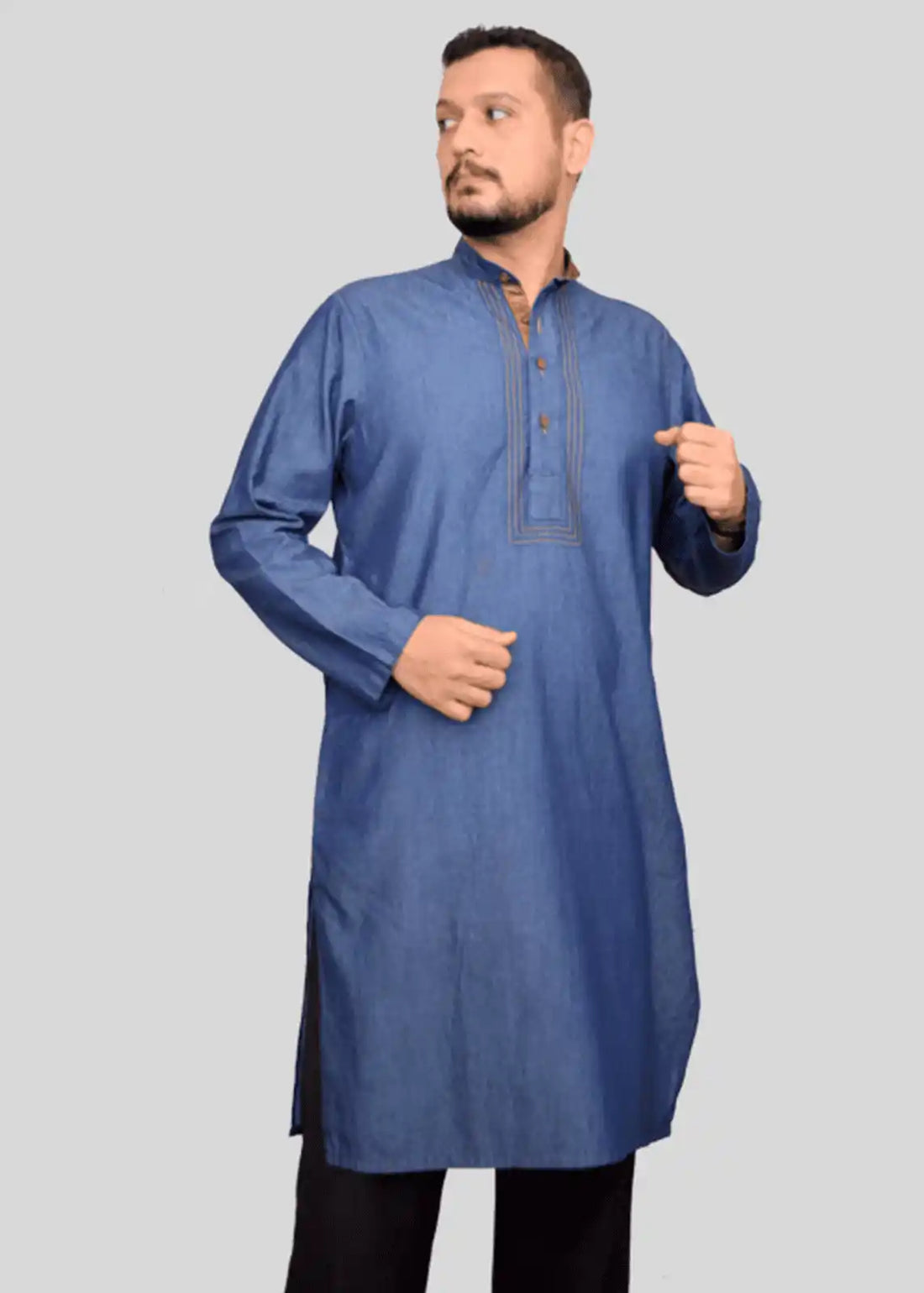 Man wearing a blue kurta against a gray background