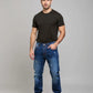 Man wearing a black t-shirt and blue jeans on a gray background