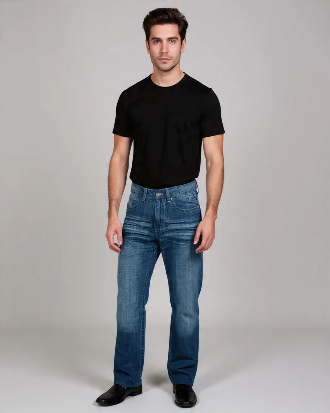 Man wearing a black t-shirt and blue jeans against a gray background