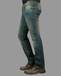 Blue jeans worn by a person on a gray background