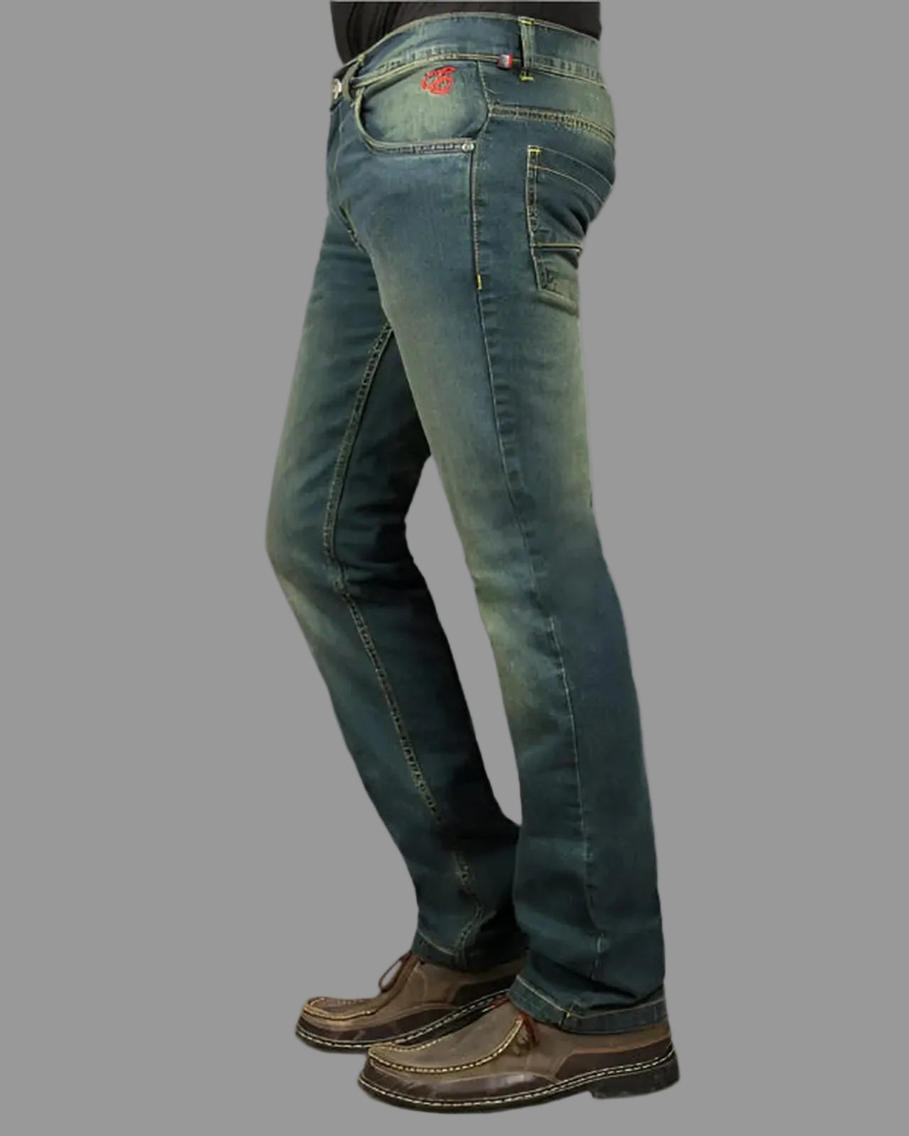 Blue jeans worn by a person on a gray background