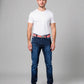 Man wearing a white t-shirt, blue jeans, and a red belt on a gray background