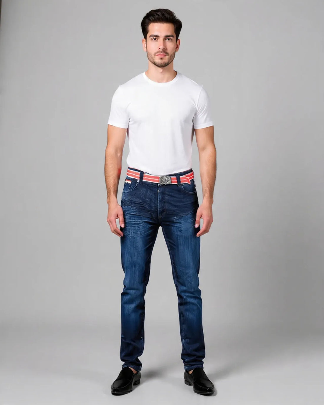 Man wearing a white t-shirt, blue jeans, and a red belt on a gray background