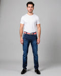 Man wearing a white t-shirt, blue jeans, and a red belt on a gray background