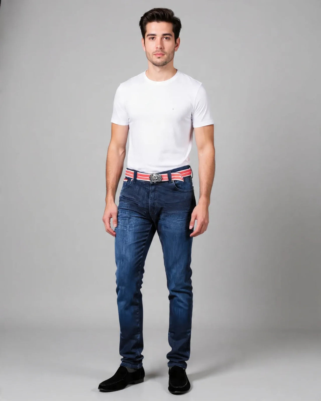Man wearing a white t-shirt, blue jeans, and a red belt on a gray background