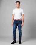 Man wearing a white t-shirt, blue jeans, and black shoes on a gray background