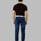 Man wearing blue jeans and a black t-shirt on a gray background