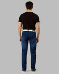 Man wearing blue jeans and a black t-shirt on a gray background