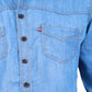 Close-up of a blue denim shirt with buttons and a pocket on a white background