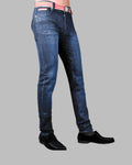 Blue jeans worn by a person on a gray background