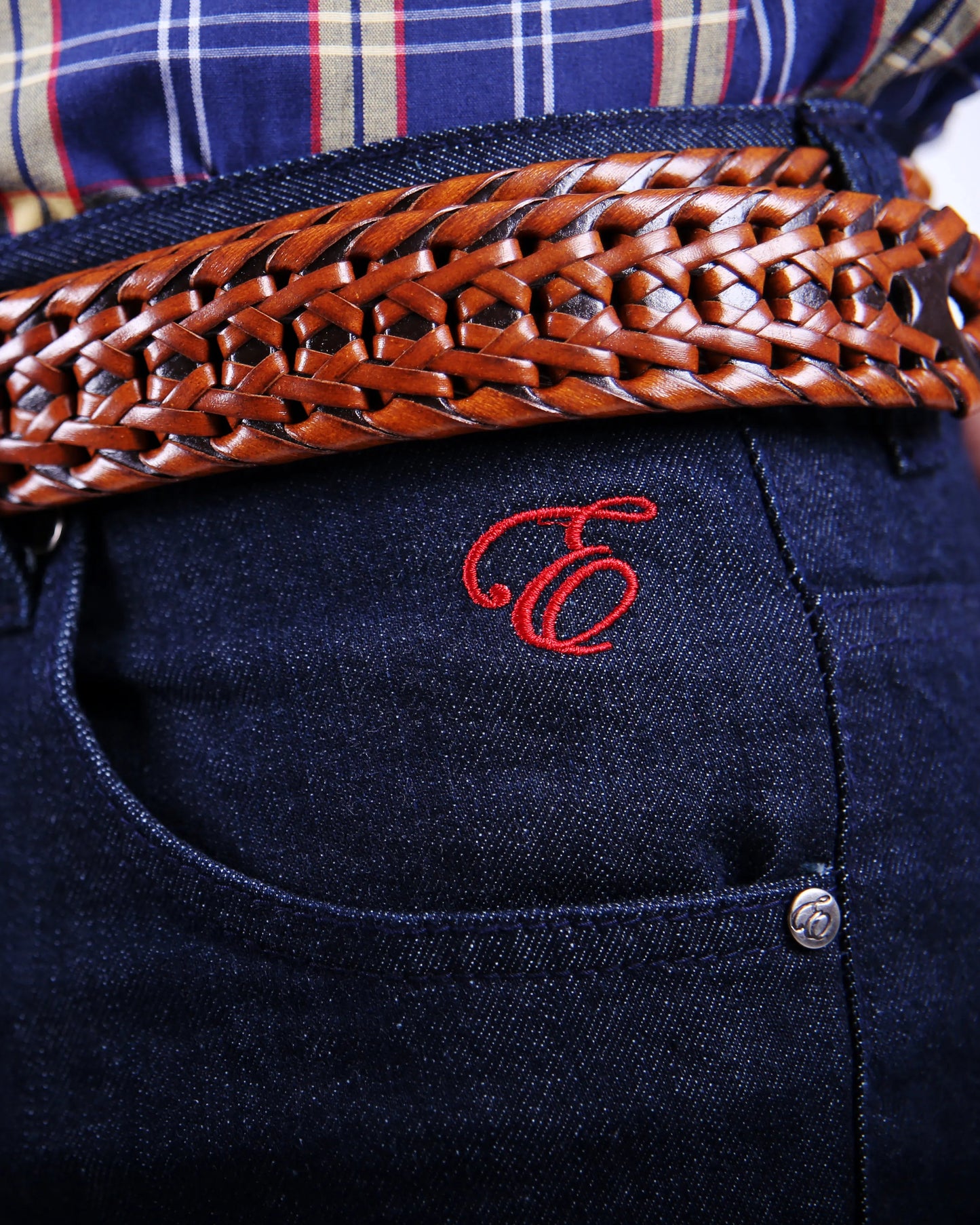 Denim jeans with red embroidered logo and embossed Rivet.