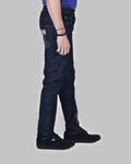 Person wearing dark blue jeans on a gray background