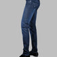 Blue jeans worn by a person on a gray background