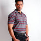 Man wearing a striped polo shirt and dark jeans on a white background