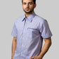 Man wearing a short-sleeve checkered shirt against a black background