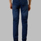 Person wearing blue jeans on a gray background