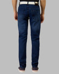 Person wearing blue jeans on a gray background