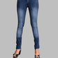 Blue jeans worn by a person on a gray background