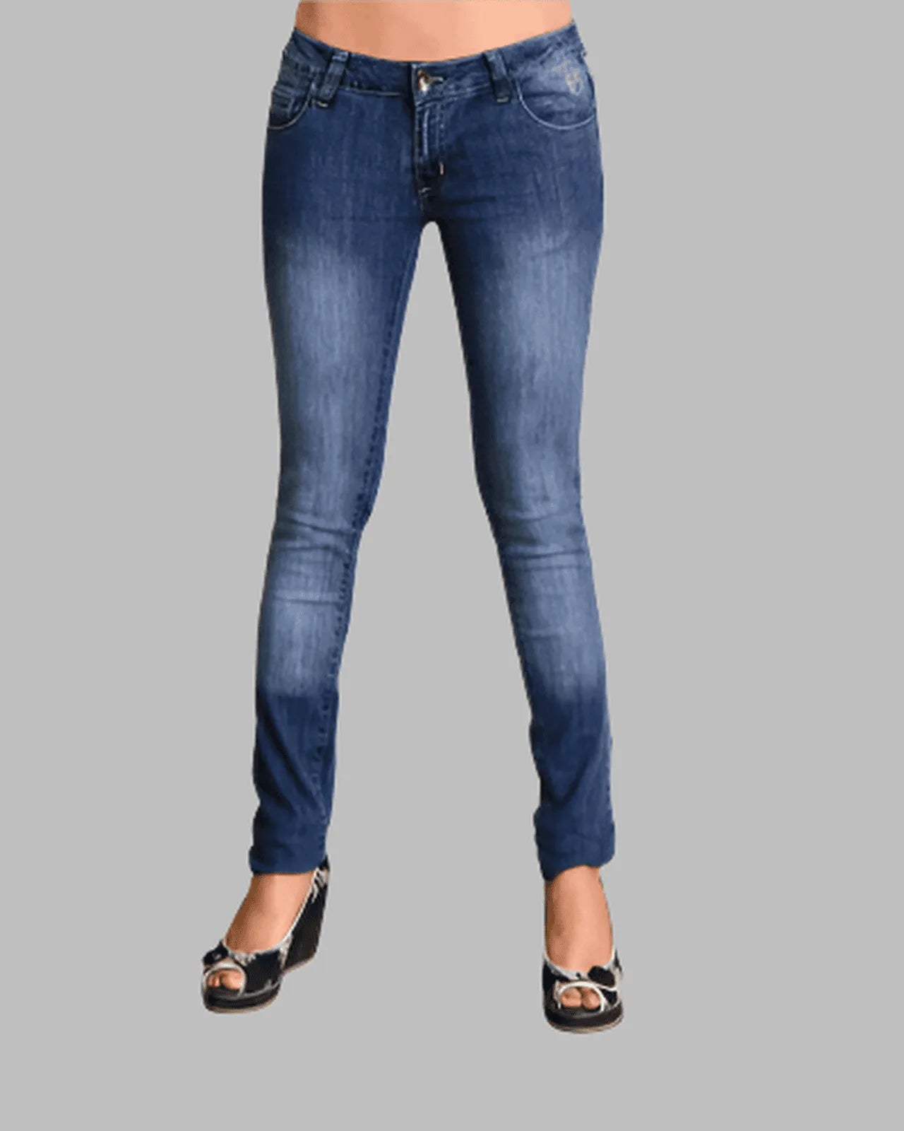 Blue jeans worn by a person on a gray background