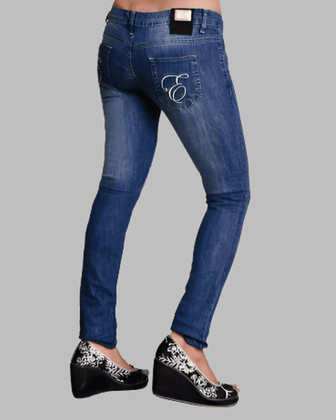 Blue jeans with a brand logo on a gray background