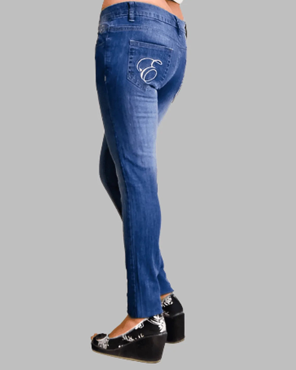 Blue jeans with a brand logo on the pocket against a gray background