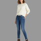 Woman wearing a white sweater and blue jeans on a white background