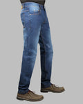 Blue jeans worn by a person on a gray background