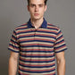 Man wearing a striped polo shirt against a gray background