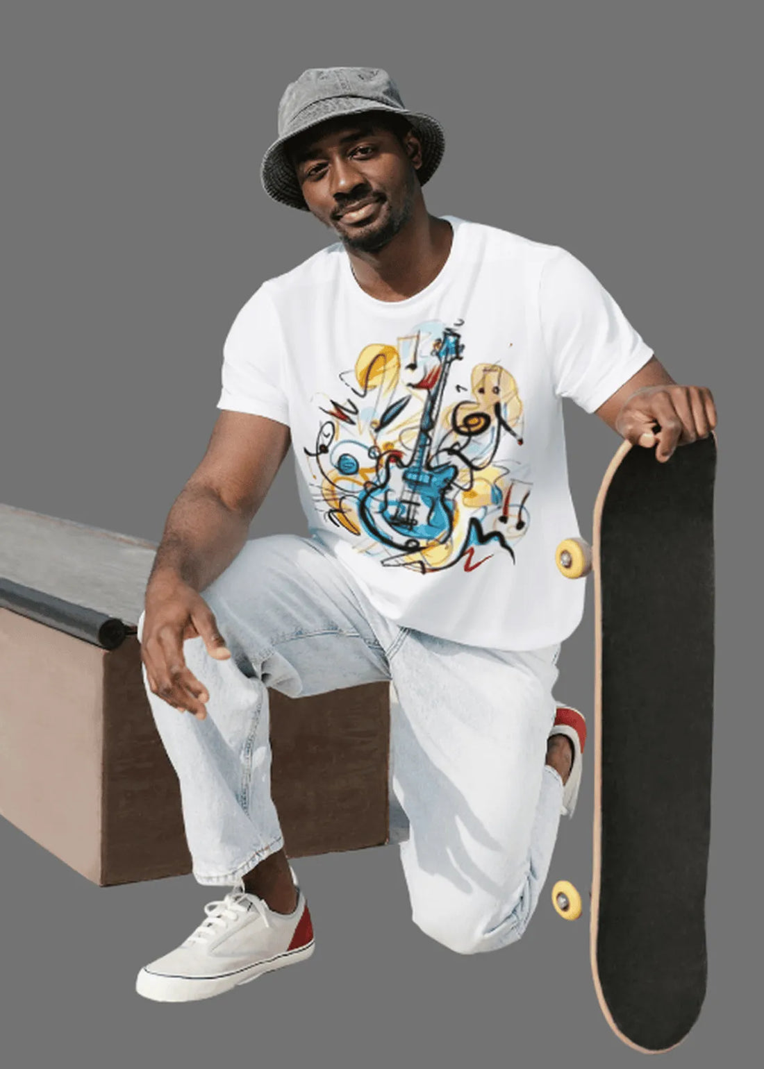 Man sitting on a skateboard ramp holding a skateboard, wearing a white t-shirt with a colorful graphic design.