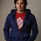Man wearing a blue hoodie over a red shirt with white text on a plain background