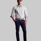 Man wearing a checkered shirt, blue jeans, and black shoes on a white background