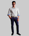 Man wearing a checkered shirt, blue jeans, and black shoes on a white background