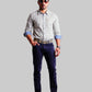 Man wearing a checkered shirt, dark  navy twill pants, and sunglasses on a white background
