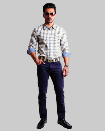 Man wearing a checkered shirt, dark  navy twill pants, and sunglasses on a white background