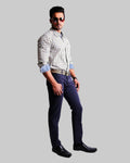 Man wearing a checkered shirt, dark pants, and sunglasses on a white background