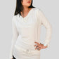 Woman wearing a white long-sleeve top and sunglasses on a plain background